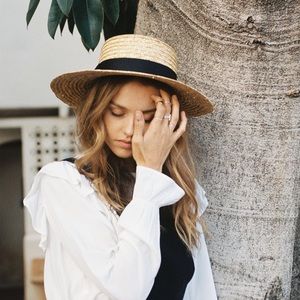 straw boater hat Trimmed with a Black ribbon